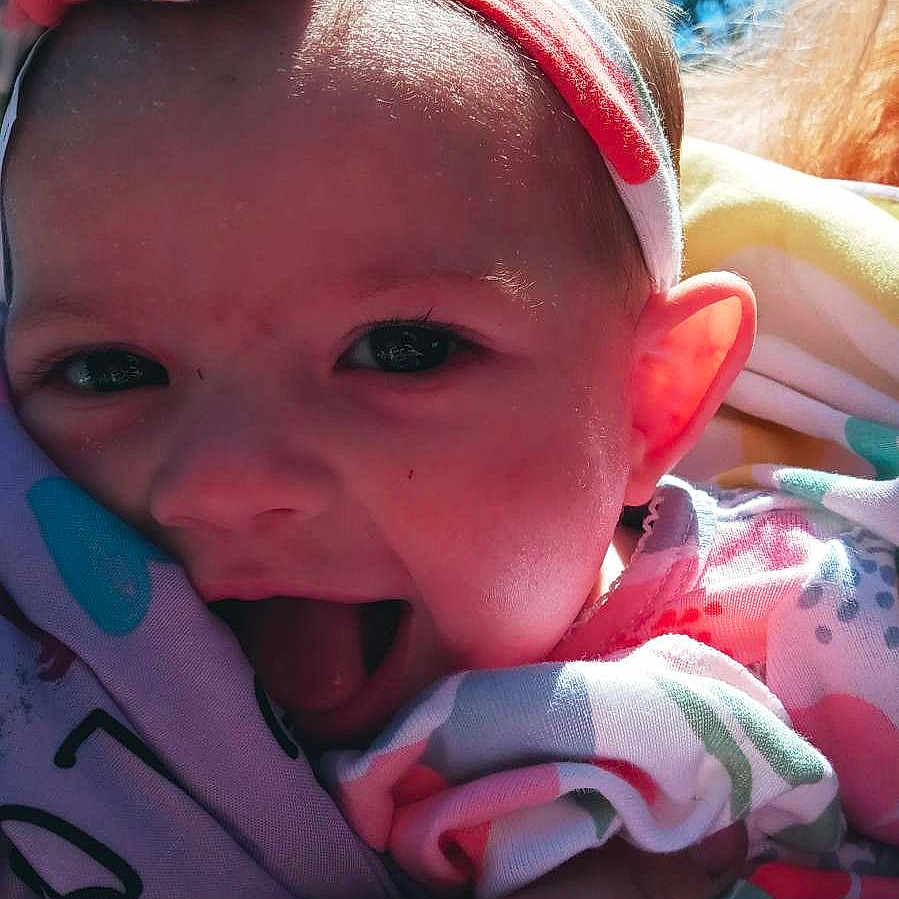 Paisley is registered to the contest to win money with this photo: baby, cap, cheek, chin, eye, eyebrow, face, finger, happy, head, headgear, human_body, iris, lip, mouth, nose, pink, skin, smile, textile