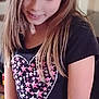 Madalynn is registered to the contest to win money with this photo: child, girl, long_hair, black_shirt, heart_design, stars, indoor, portrait, smiling, casual_clothing, young_person, candid, soft_lighting, relaxed, happy, standing, closeup, youth, tshirt, natural_pose