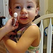 Bayleigh is registered to the contest to win money with this photo: toddler, child, marker, table, chair, striped_dress, indoor, face, person, curious, big_eyes, hand, hair, door, home, furniture, tablecloth, colorful, casual, candid