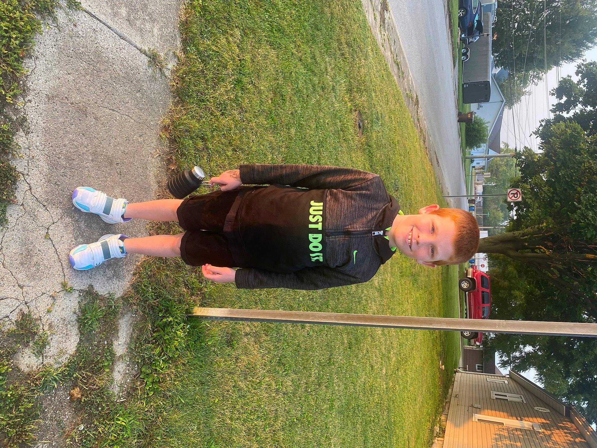 Maverick is registered to the contest to win money with this photo: asphalt, fun, grass, human_leg, joy, knee, leisure, outdoor_shoe, people_in_nature, person, plant, recreation, shrub, tree, walking_shoe