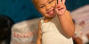 Nyalia is registered to the contest to win money with this photo: accessories, bodypart, bracelet, child, clothing, diaper, face, female, finger, girl, hair, hand, happy, head, person, photography, portrait, shorts, smile, t_shirt