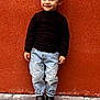 Célyan a rejoint le concours — aidez-le/la à gagner de superbes lots ! child, boy, smile, black_turtleneck, blue_jeans, boots, standing, orange_wall, outdoor, pavement, casual_clothing, portrait, happy, fashion, cute, young, person, full_body, urban, playful