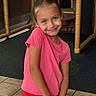 child, girl, pink_shirt, red_skirt, smiling, indoor, play_structure, tile_floor, posing, young, happy, casual_clothing, cute, portrait, person, childhood, leisure, play_area, fun, expression