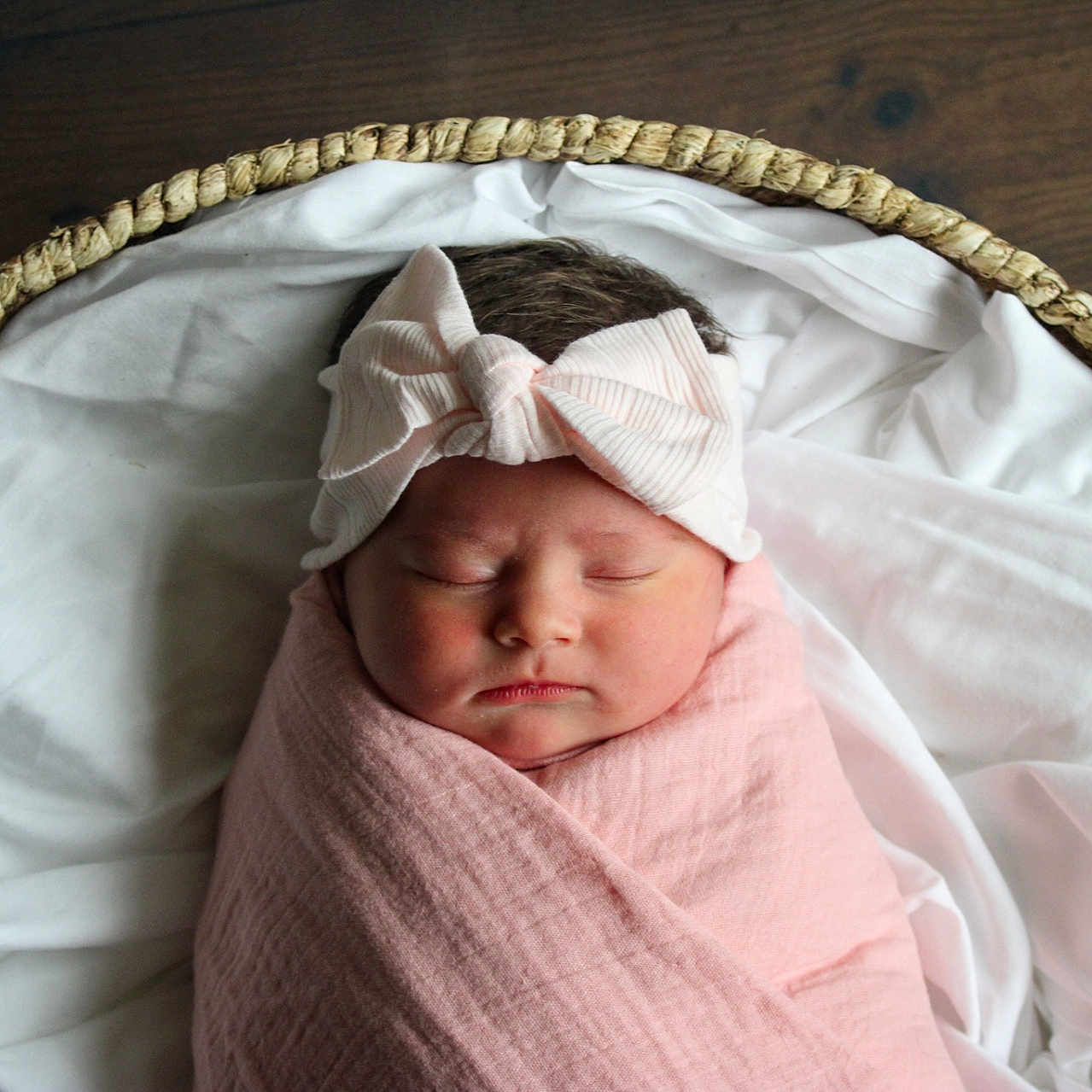 Liliana is registered to the contest to win money with this photo: baby, basket, blanket, bow, child, closeup, cute, headband, indoors, infant, newborn, peaceful, portrait, resting, sleeping, soft_lighting, swaddled, white_fabric, wooden_floor, wrapped