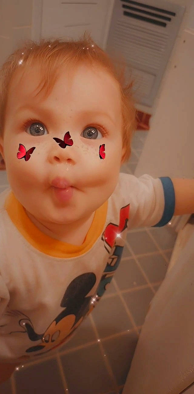 Lilliana is registered to the contest to win money with this photo: baby, baby_toddler_clothing, cheek, child, chin, close_up, ear, eyebrow, eyelash, gesture, hairstyle, happy, jaw, lip, mouth, neck, nose, person, skin, thumb