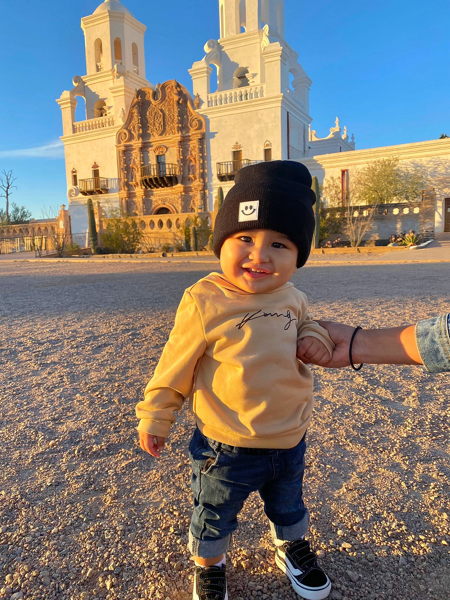 Kenai joined the competition — help win amazing prizes! baseball_cap, building, cap, fun, grass, happy, headgear, headwear, joy, landscape, leisure, people_in_nature, person, sand, sky, smile, sunlight, tints_and_shades, toddler, tower