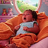 baby, blanket, chair, child, cute, decor, expression, indoor, infant, nursery, orange, pink, polka_dot_clothing, portrait, relaxing, shelf, soft_toys, sunlight, teddy_bear, window