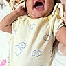 baby, infant, smiling, yawning, onesie, cloud_pattern, bed, blanket, pillow, cute, happy, child, sleepwear, lying_down, indoors, soft_toys, cozy, person, newborn, portrait