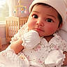 Amelia is registered to the contest to win money with this photo: baby, blanket, child, closeup, cozy, crib, cute, floral_outfit, hat, indoors, infant, mittens, mobile, nursery, pink_wallpaper, portrait, sleepwear, smiling, soft_light, window
