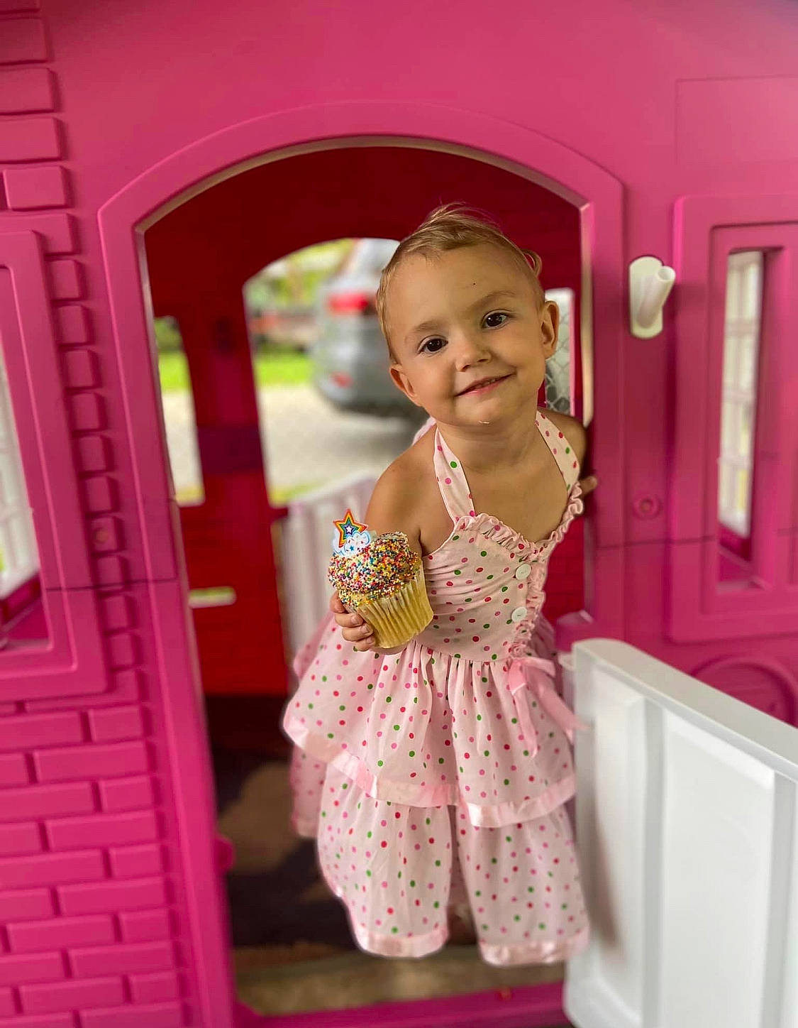 Stevie is registered to the contest to win money with this photo: baby, baby_toddler_clothing, child, day_dress, door, dress, fashion_design, fun, happy, joy, magenta, one_piece_garment, pattern, peach, person, pink, play, purple, room, sleeve