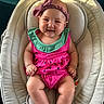 baby, infant, child, smiling, portrait, seated, bouncer, baby_seat, pink_outfit, green_collar, bow_headband, watermelon_pattern, bare_feet, indoors, happy, cute, face, playful, closeup, photography