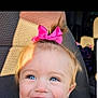 baby, blue_eyes, car_seat, cheeks, child, close_up, eyelashes, hair_bow, happy, head, passenger, pink_bow, playful, portrait, seat, shadow, smile, sunlight, toddler, vehicle_interior