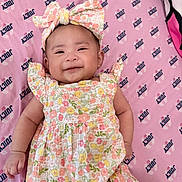 Princess joined the competition — help win amazing prizes! baby, infant, smiling, floral_dress, headband, pink_blanket, juicy_logo, cute, lying_down, happy, child, portrait, apparel, patterned_clothing, one_person, indoors, closeup, skin, baby_girl, small_child