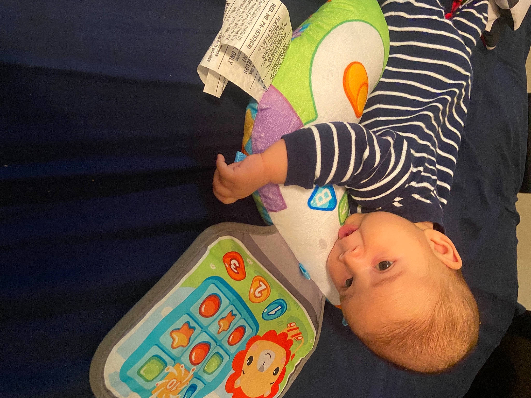 Manuel is registered to the contest to win money with this photo: baby, baby_products, child, eyelash, finger, fun, gesture, hand, happy, human_leg, nail, orange, pattern, person, play, recreation, room, sitting, stuffed_toy, thumb