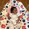 newborn, baby, infant, sleeping, portrait, child, face, hand, onesie, little_sister, pink, blanket, floral, flowers, play_mat, indoor, wood_floor, chair, relaxed, adorable