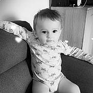 Eden Sigler participe au concours pour gagner de l'argent avec cette photo : arm, baby, black_and_white, blanket, child, clothing, couch, cute, eyes, face, hair, heart_shape, indoors, infant, legs, long_sleeve, pacifier, relaxing, sofa, toy