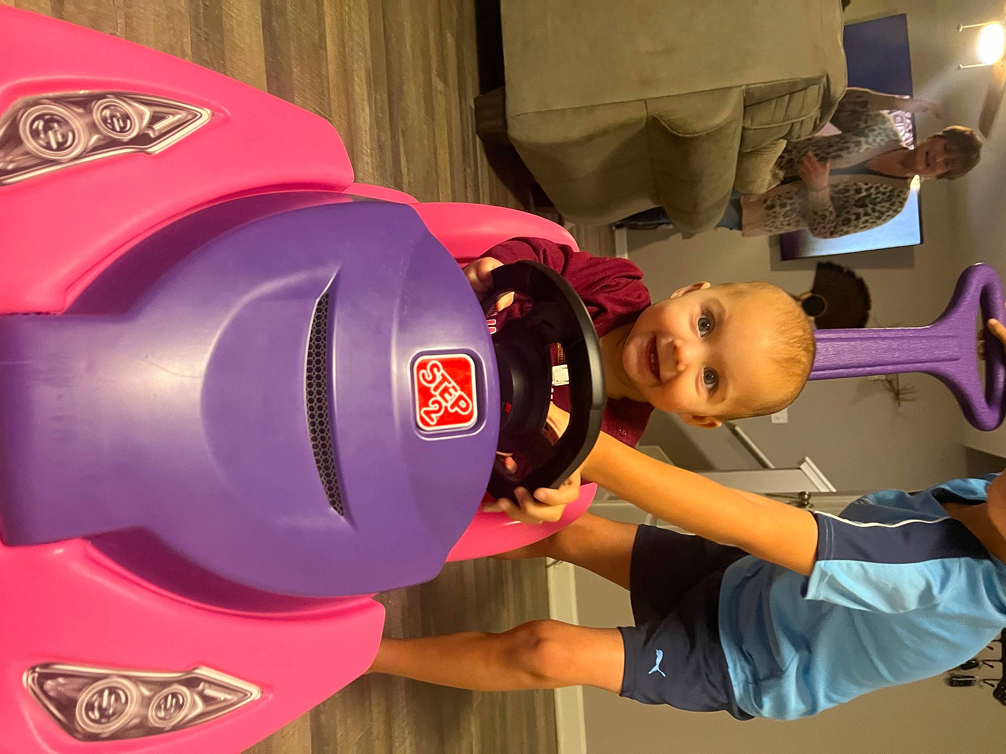 Brooklynne is registered to the contest to win money with this photo: animation, automotive_design, carmine, child, curtain, fun, hat, helmet, joy, leisure, logo, machine, magenta, person, personal_protective_equipment, recreation, red, room, shorts, t_shirt