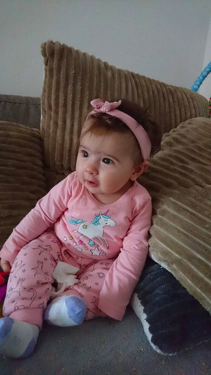 Gabriela participe au concours pour gagner de l'argent avec cette photo : baby, baby_toddler_clothing, cheek, child, eye, person, pink, sitting, skin, toddler