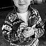 Enverson joined the competition — help win amazing prizes! child, boy, indoor, black_and_white, smile, face, hairstyle, mohawk, fleece_jacket, patterned_clothing, pants, holding_object, curious, standing, floor, cozy, portrait, young, casual_clothing, cute