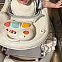 baby, infant, walker, smile, happy, child, indoor, toy, bib, striped_shirt, floor, wooden_floor, reaching_out, face, person, young_child, seat, playtime, cute, expression