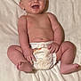 baby, smiling, diaper, blanket, infant, happy, lying_down, cute, skin, young_child, soft_texture, face, bare_chest, small_hands, small_feet, indoors, child, portrait, relaxing, comfort