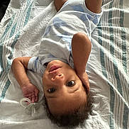 Kasai joined the competition — help win amazing prizes! baby, infant, child, pacifier, blanket, striped_blanket, lying_down, looking_up, curious, hand_on_head, clothing, short_sleeves, indoors, soft_light, portrait, young_child, cute, relaxed, resting, person