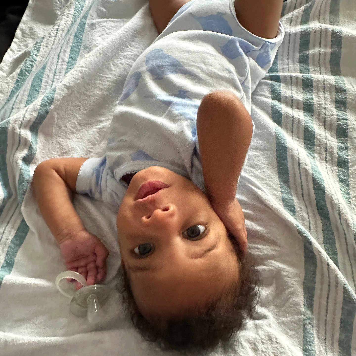 Kasai joined the competition — help win amazing prizes! baby, infant, child, pacifier, blanket, striped_blanket, lying_down, looking_up, curious, hand_on_head, clothing, short_sleeves, indoors, soft_light, portrait, young_child, cute, relaxed, resting, person