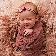 Louanne joined the competition — help win amazing prizes! baby, newborn, infant, swaddled, wrapped, blanket, fur, headband, smile, peaceful, portrait, studio, soft_texture, cozy, pink, rose, face, hand, eyes_closed, skin