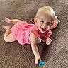 baby, child, pink_dress, smiling, pacifier, carpet, indoor, cute, happy, toddler, toy, stuffed_animal, playful, infant, casual, portrait, young_child, crawling, bright, person