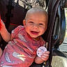 Lettie joined the competition — help win amazing prizes! baby, smiling, pacifier, onesie, whale_pattern, stroller, sunlight, shadow, happy, child, infant, seatbelt, outdoor, cute, person, clothing, skin, hand, head, portrait