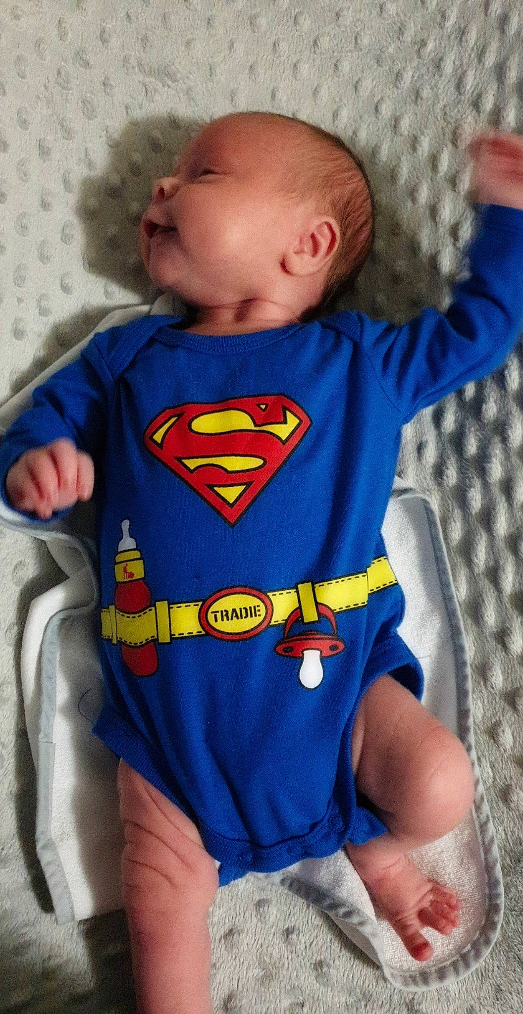 Kyran is registered to the contest to win money with this photo: arm, baby, baby_products, baby_toddler_clothing, batman, child, costume, fictional_character, headwear, justice_league, person, product, superhero, superman, toddler