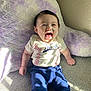 baby, child, smiling, laughing, sitting, indoor, pillow, purple, plush, shirt, pants, sunlight, shadow, happy, cute, person, face, infant, cozy, wall