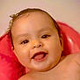 Yesenia is registered to the contest to win money with this photo: baby, background, child, closeup, cushion, cute, expression, face, happy, head, indoors, infant, person, pink, portrait, skin, smiling, tongue, warm, young