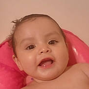 Yesenia is registered to the contest to win money with this photo: baby, bright, cheeks, child, closeup, cute, expression, eyes, face, happy, head, indoors, infant, mouth, person, pink_cushion, portrait, skin, smiling, young_child
