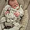 baby, pacifier, toy, elephant_toy, car_seat, baby_clothing, knitwear, infant, child, cushion, straps, seat_belt, soft_texture, hand, face, sleepy, cute, indoors, comfort, newborn