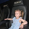Layana joined the competition — help win amazing prizes! 14, armrest, blue_dress, bow, casual, child, cinema, entertainment, expression, girl, indoor, leisure, person, pigtails, portrait, premier, seat_number, side_eye, theater_seat, young