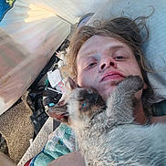 Din joined the competition — help win amazing prizes! person, cat, siamese_cat, face, lying_down, cuddle, indoor, tent, blanket, hair, blue_eyes, furry, close_up, resting, quilt, young_adult, casual, relaxed, chain_necklace, messy_hair