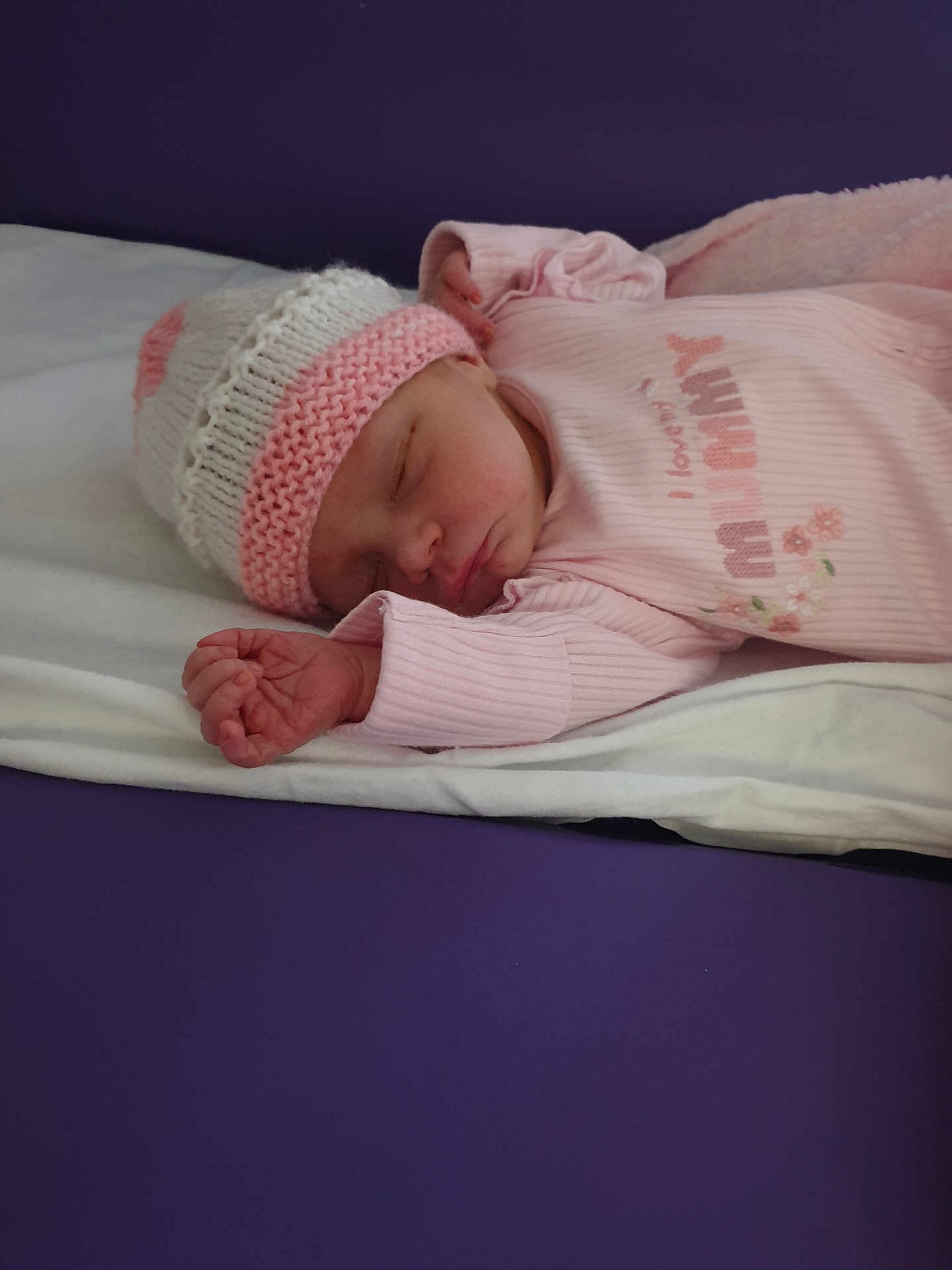 Erica joined the competition — help win amazing prizes! baby, newborn, sleeping, hat, pink_clothing, blanket, soft, infant, cozy, resting, peaceful, cute, portrait, child, indoors, sleepwear, knitted_hat, human, lying_down, toddler