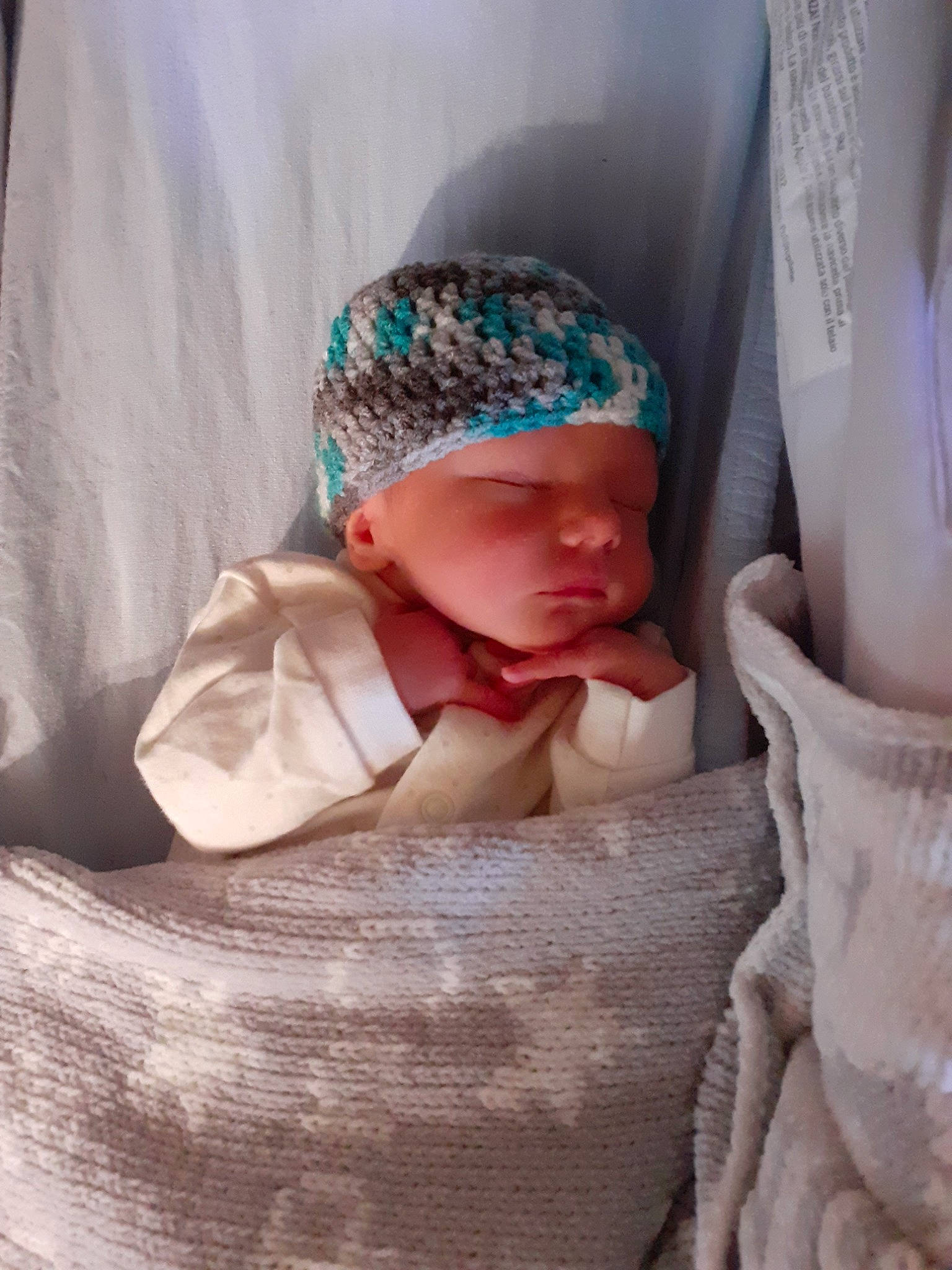 Logan is registered to the contest to win money with this photo: baby, beanie, bonnet, cap, child, headgear, headwear, knit_cap, knitting, person, toddler