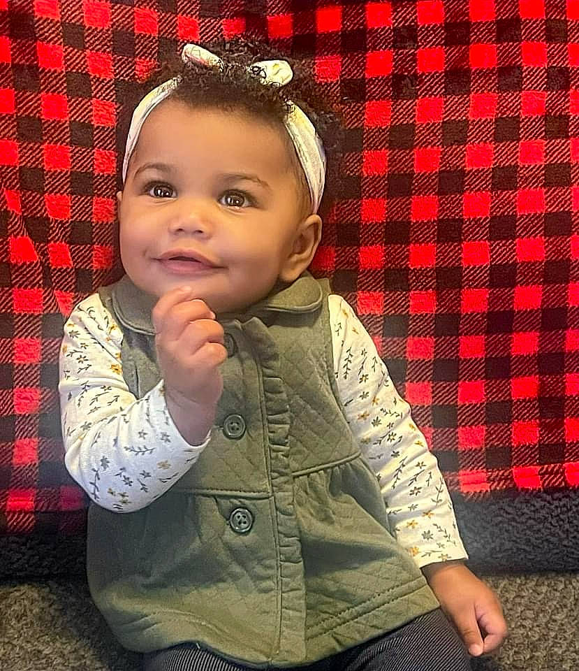 Imani is registered to the contest to win money with this photo: baby_toddler_clothing, cheek, chin, dress, eye, face, flash_photography, hair, hairstyle, happy, head, human, human_body, joy, lip, nose, person, red, skin, sleeve