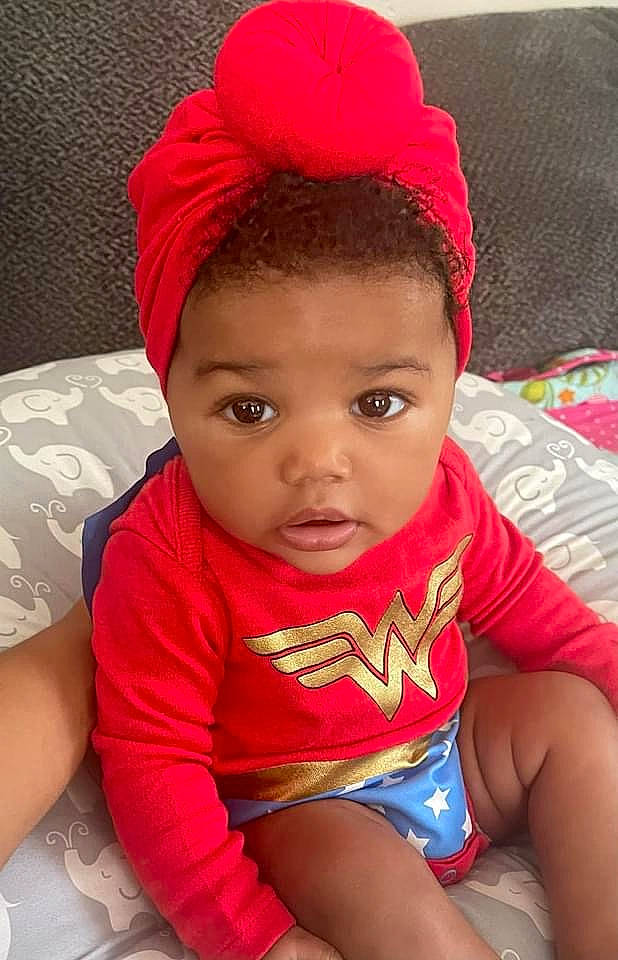 Imani joined the competition — help win amazing prizes! arm, baby_toddler_clothing, cap, cheek, chin, eye, eyelash, face, happy, head, human_body, lip, mouth, neck, nose, person, pink, red, skin, textile