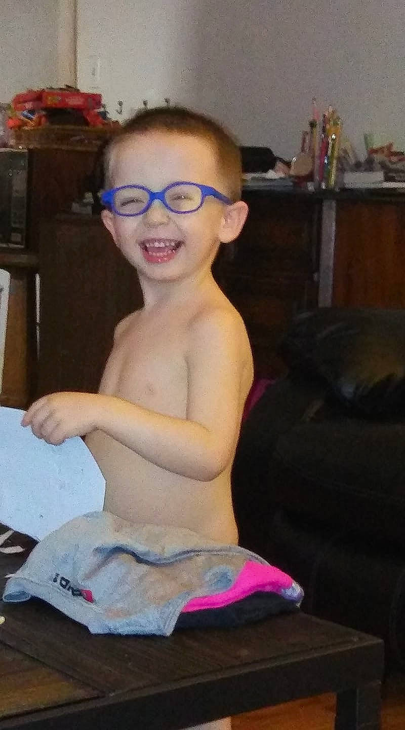 Zacharia is registered to the contest to win money with this photo: arm, art, chest, child, eyewear, fun, glasses, head, joint, joy, leg, muscle, person, shoulder, sitting, smile, toddler, vacation, vision_care