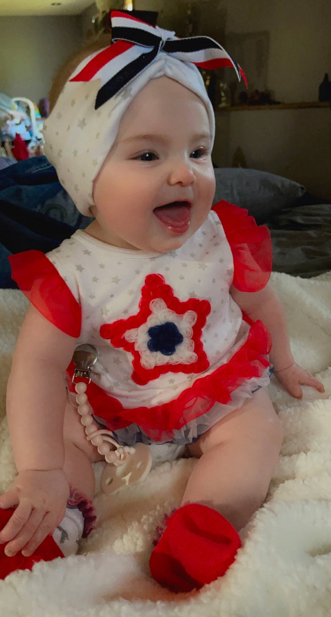 Ari is registered to the contest to win money with this photo: baby, baby_toddler_clothing, cap, cheek, dress, eye, face, happy, head, headgear, headwear, lip, outerwear, person, pink, product, red, skin, sleeve, smile