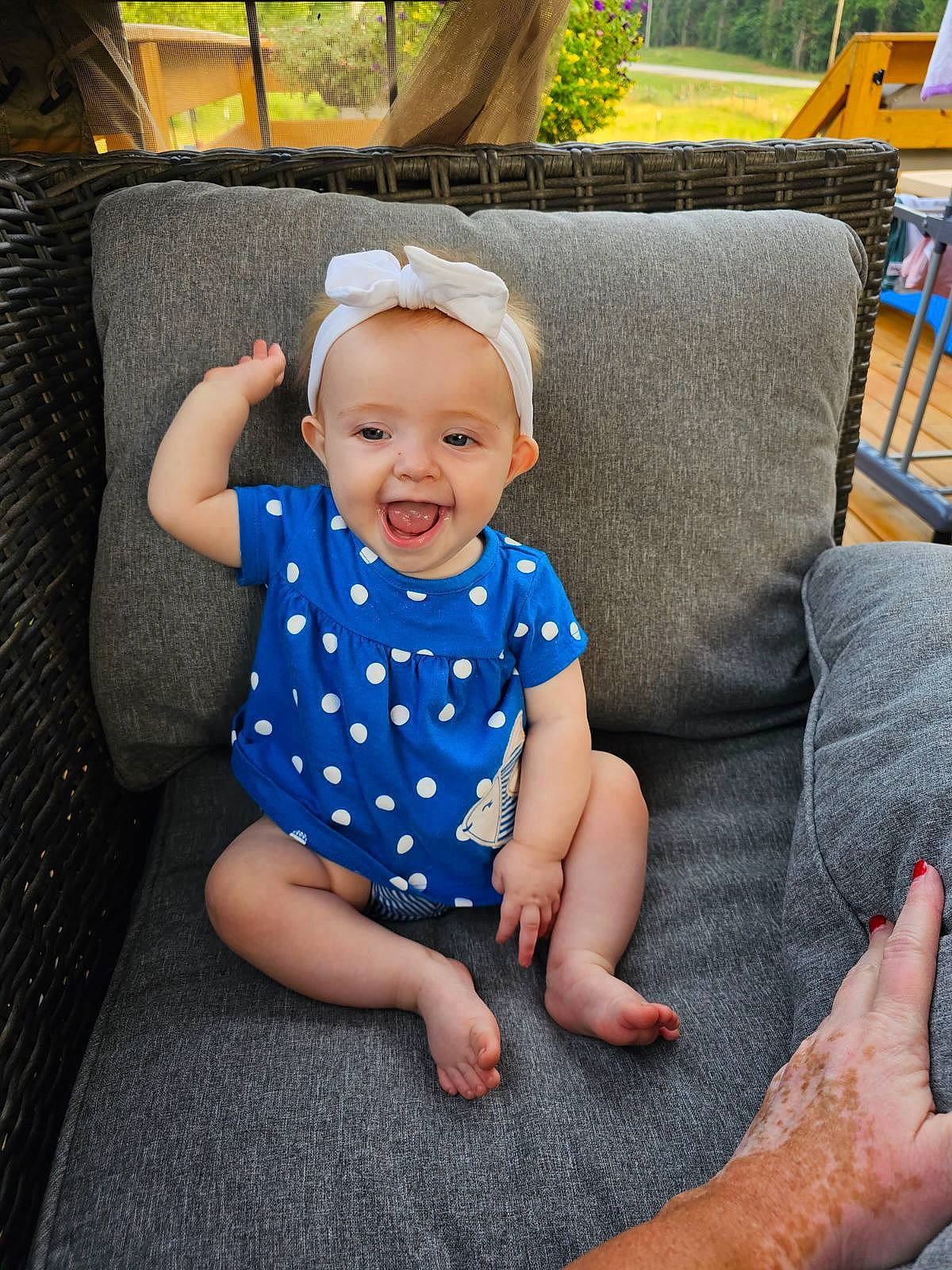 Bonnie is registered to the contest to win money with this photo: baby, baby_toddler_clothing, barefoot, child, comfort, couch, electric_blue, finger, fun, gesture, grass, happy, hat, human_leg, joy, pattern, person, sitting, sleeve, smile