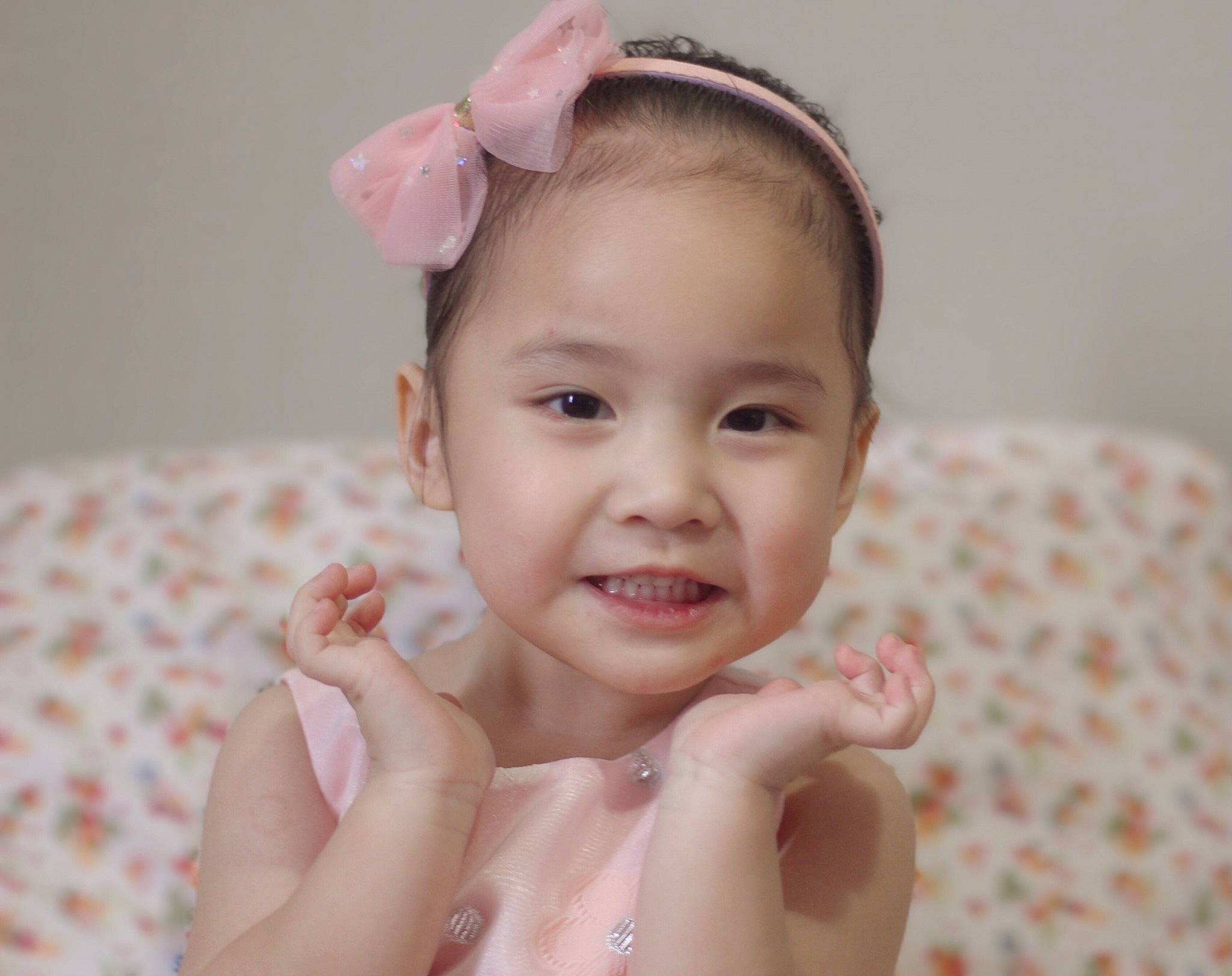 Miracle is registered to the contest to win money with this photo: baby, baby_toddler_clothing, cheek, dress, ear, eye, eyelash, flash_photography, gesture, happy, headgear, headpiece, human_body, iris, lip, neck, person, skin, smile, thumb