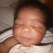 Royal is registered to the contest to win money with this photo: newborn, baby, sleeping, blanket, infant, closeup, curly_hair, skin, face, peaceful, child, soft, wrapped, indoors, portrait, young, cute, resting, human, person