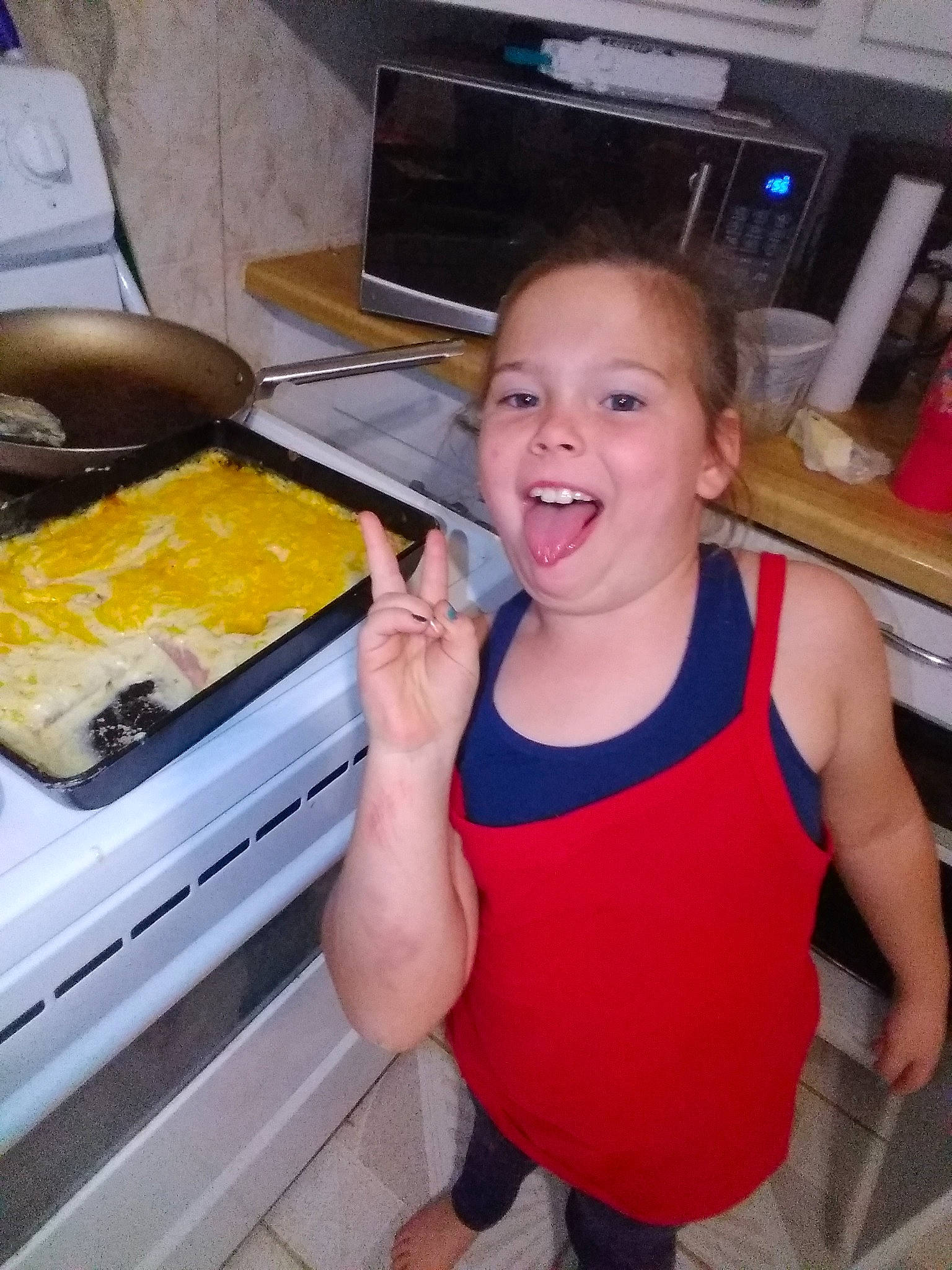 Adalyn is registered to the contest to win money with this photo: child, computer_keyboard, cooking, cuisine, food, fun, happy, home_appliance, homemaker, kitchen, kitchen_appliance, major_appliance, microwave_oven, person, recipe, room, shorts, smile, t_shirt, toddler