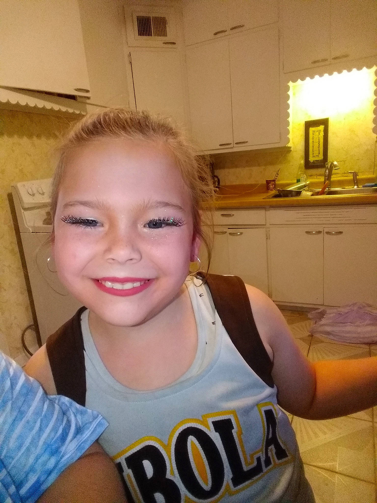 Adalyn is registered to the contest to win money with this photo: arm, cabinetry, chair, chest, ear, eyelash, forehead, happy, human_body, jaw, joint, joy, mirror, muscle, neck, person, shipping_box, shoulder, sleeveless_shirt, smile