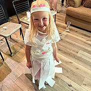 Kathy is registered to the contest to win money with this photo: child, clothing, costume, couch, diningtable, dress, face, female, furniture, girl, hardwood, hat, head, indoors, interiordesign, person, photography, portrait, table, wood