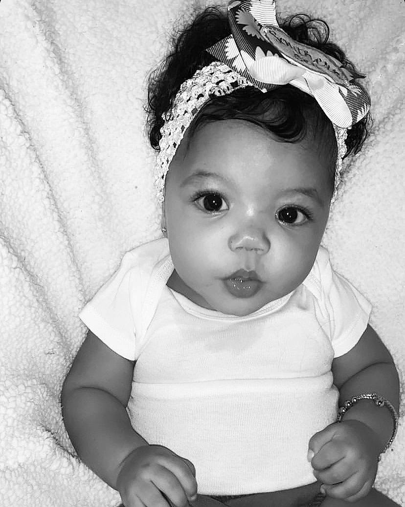 Chosen is registered to the contest to win money with this photo: baby, black_and_white, cheek, child, eye, face, hair_accessory, head, headgear, headpiece, iris, lip, monochrome, monochrome_photography, person, photograph, photography, skin, smile, toddler